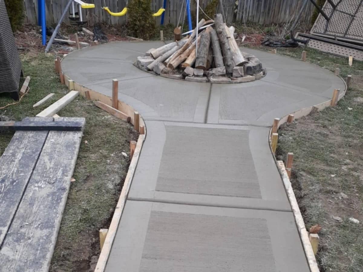 concrete sidewalk surrounding fireplace