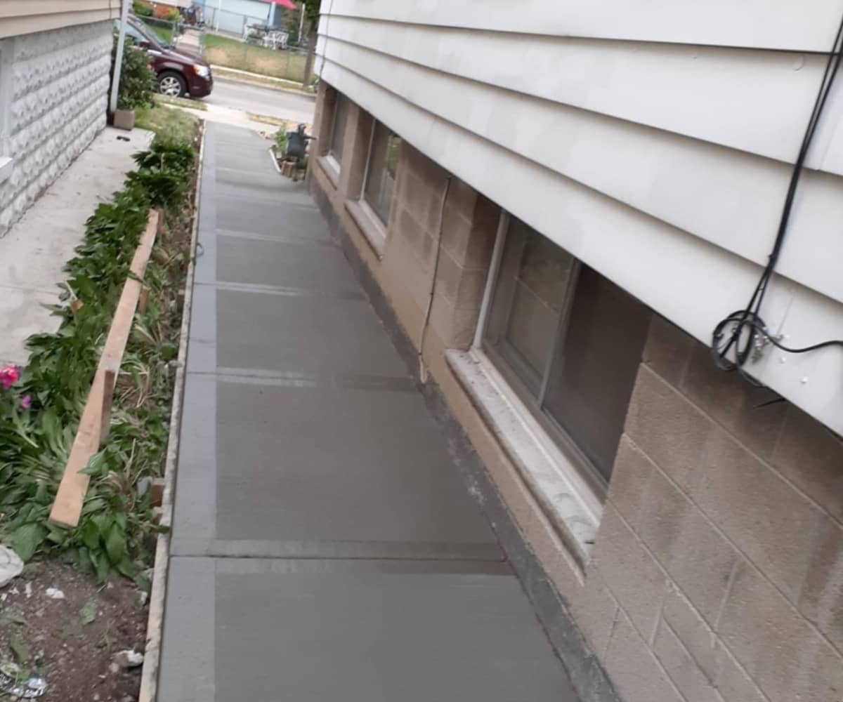 skinny concrete sidewalk next to home