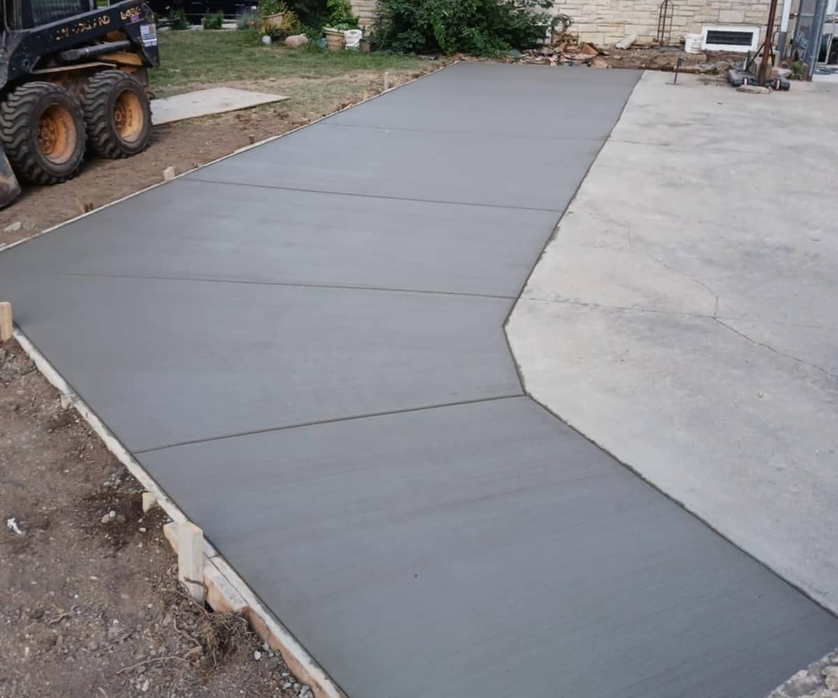 concrete sidewalk with equipment in background
